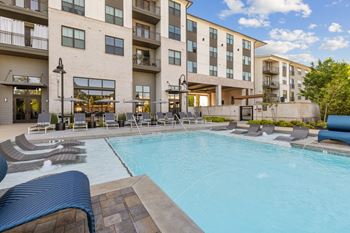 Resort-style saltwater swimming pool with tanning ledges and sundeck